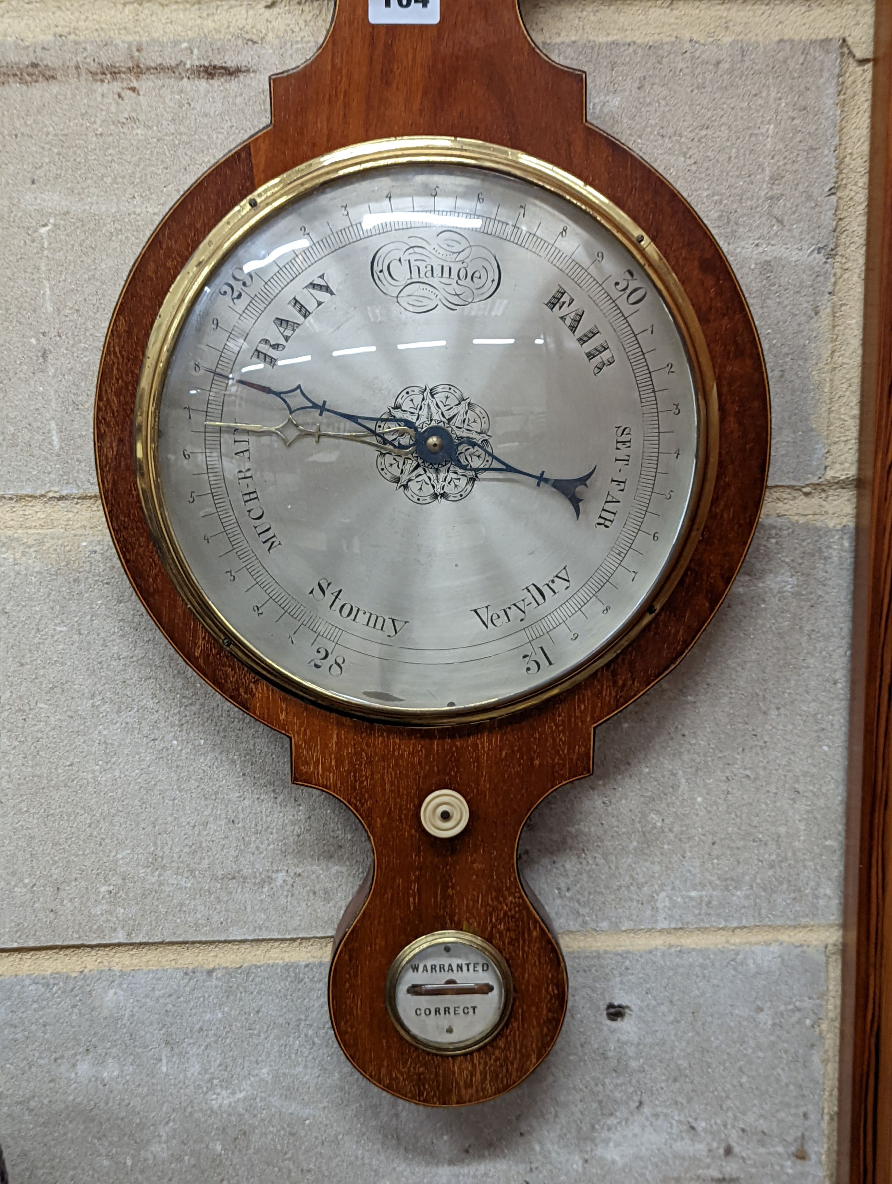 A mahogany wheel barometer. Length -107cm, W-32cm.